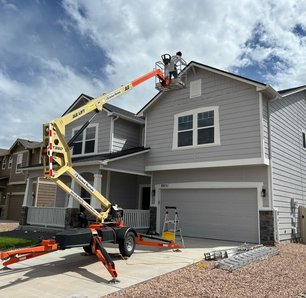 exterior house painting with a boom lift